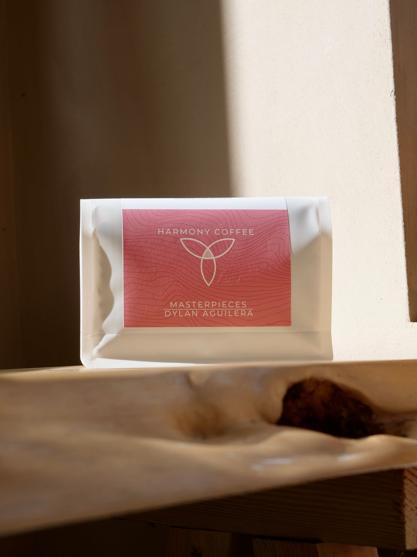 Harmony Coffee package on a wooden surface with a blurred background