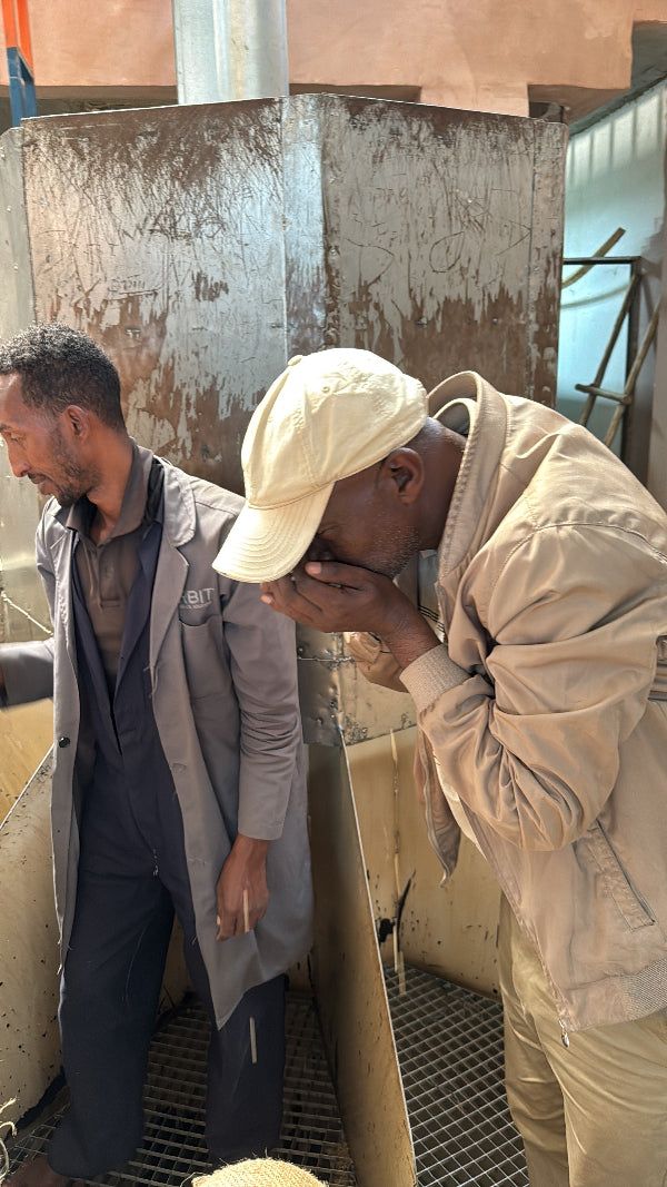 Two people working on a wooden surface with tools