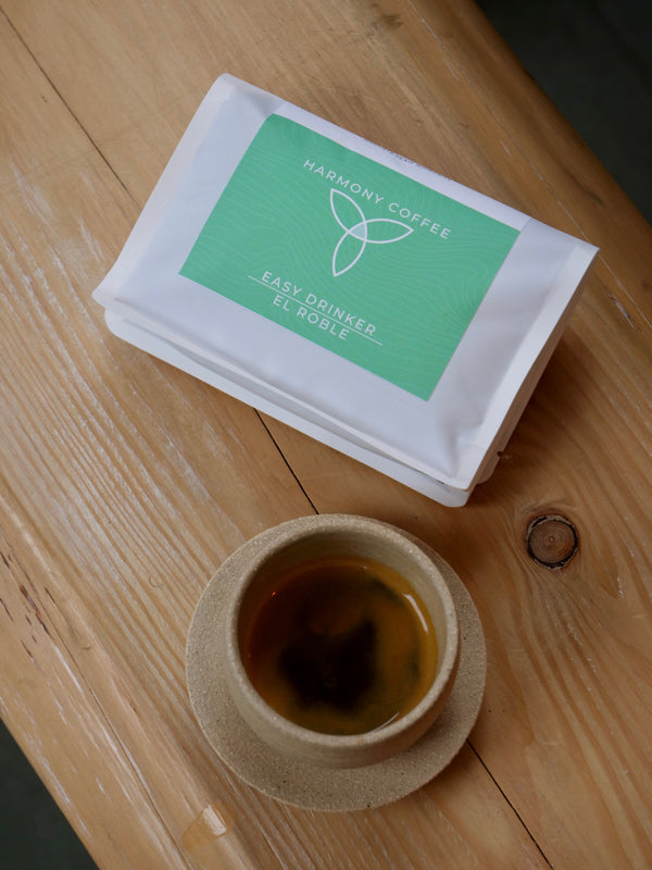 El Roble by Dylan Aguilera - Single Origin Costa Rican coffee sat on a wooden shelf in good lighting. Sat next to an Espresso. Roasted By Harmony Coffee York
