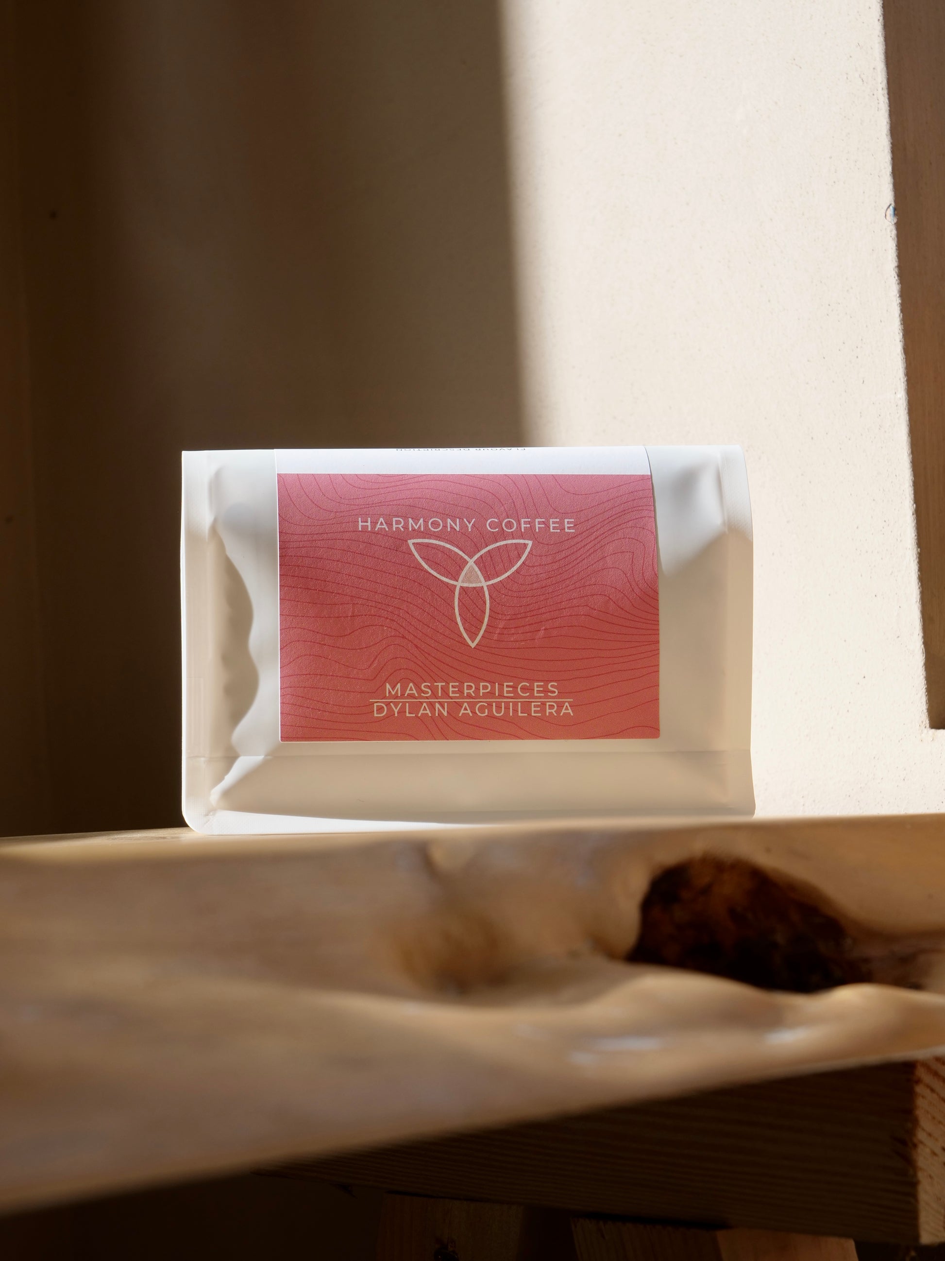 Harmony Coffee package on a wooden surface with a blurred background