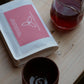Harmony Coffee package with a glass and ceramic cup on a wooden surface