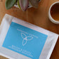 Harmony Coffee package on a wooden surface with a plant in the background