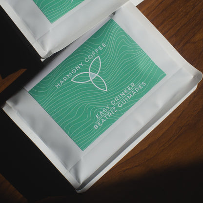 Two packets of Beatriz Guimares Anaerobic Natural Harmony Coffee on a wooden surface
