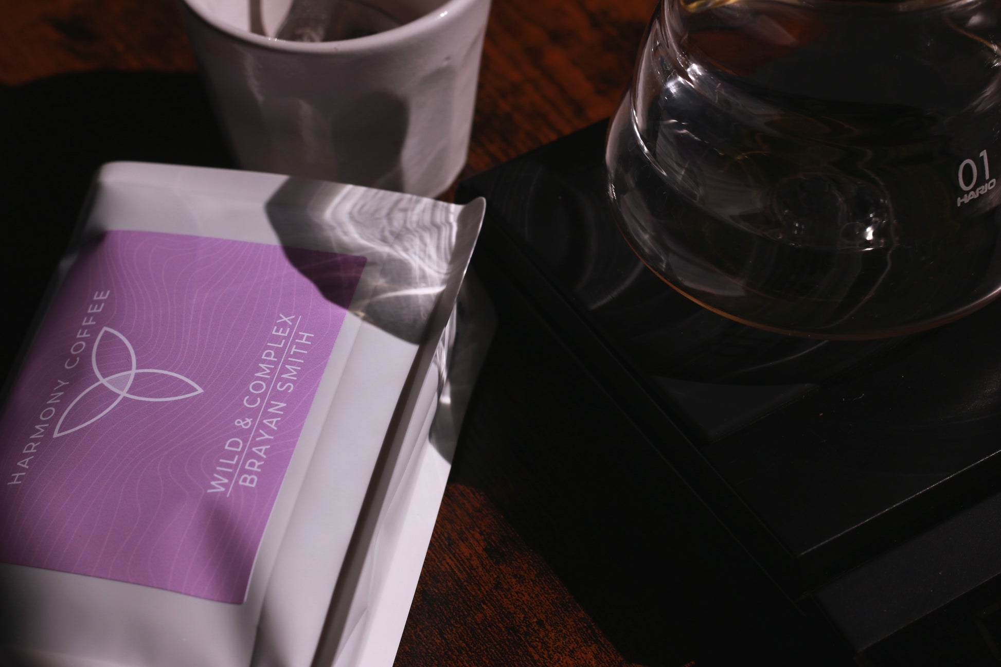 Harmony Coffee package Brayan Smith with a coffee filter and mug on a wooden surface