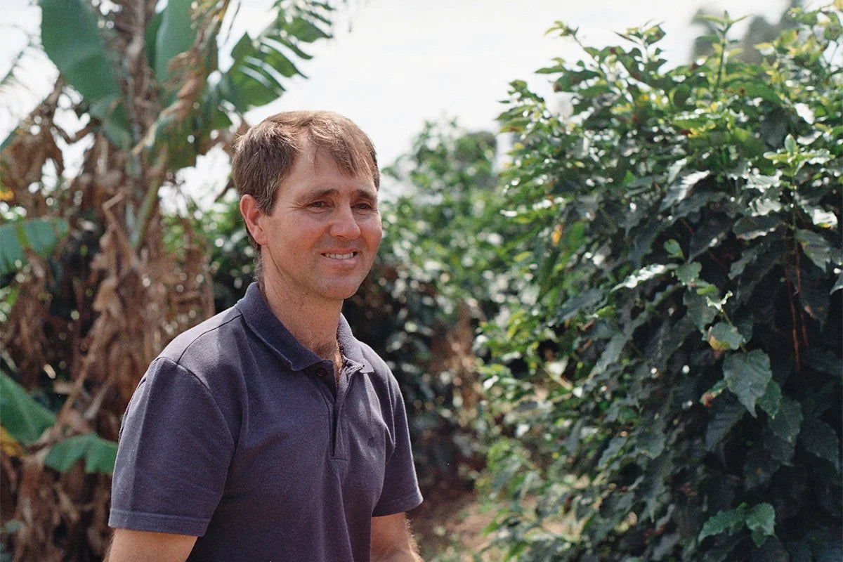 Paulo Agualetti from Sitio Agua Fria standing among his coffee trees.
