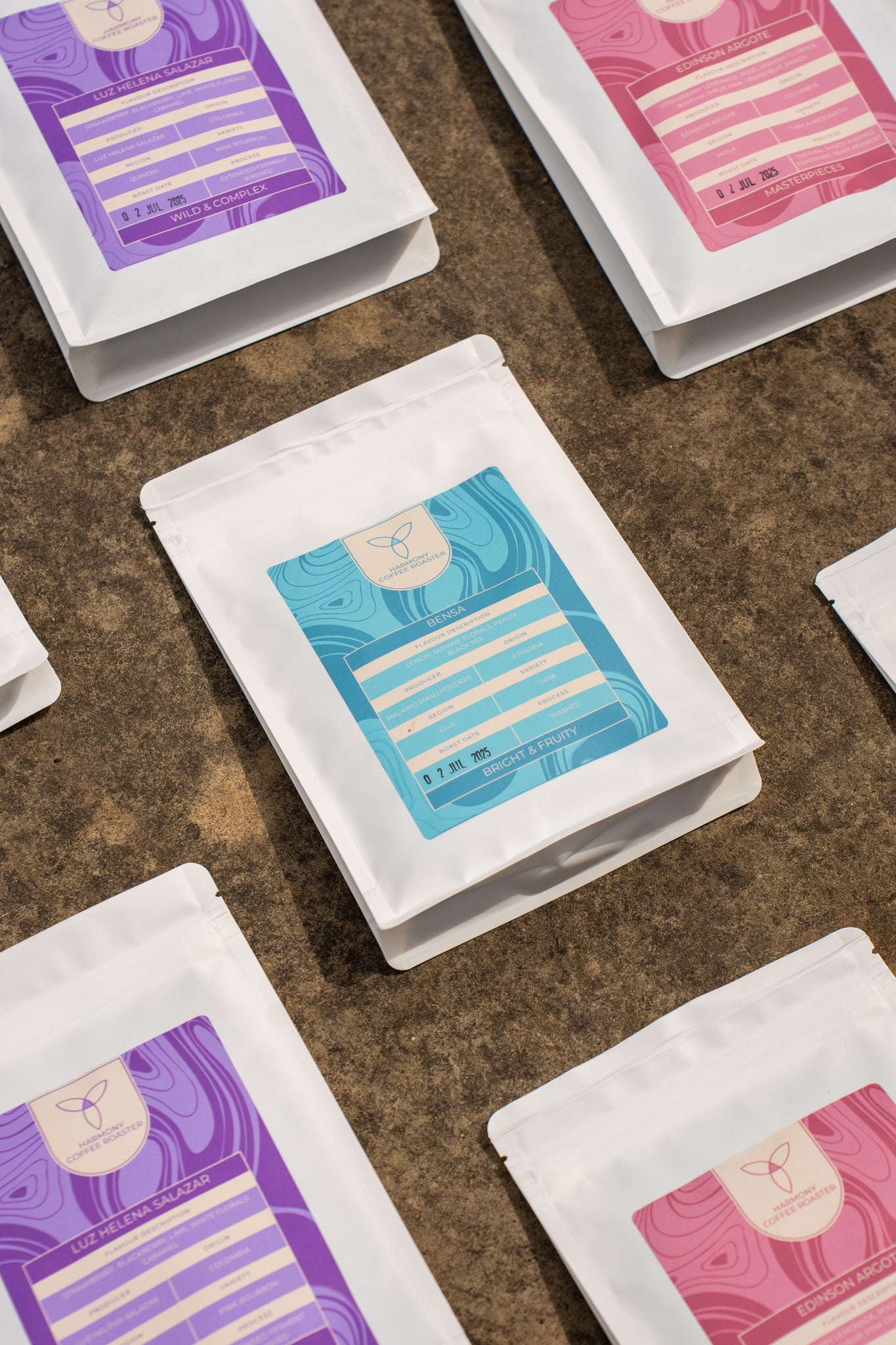 White Coffee Subscription packages with colourful labels on a brown surface