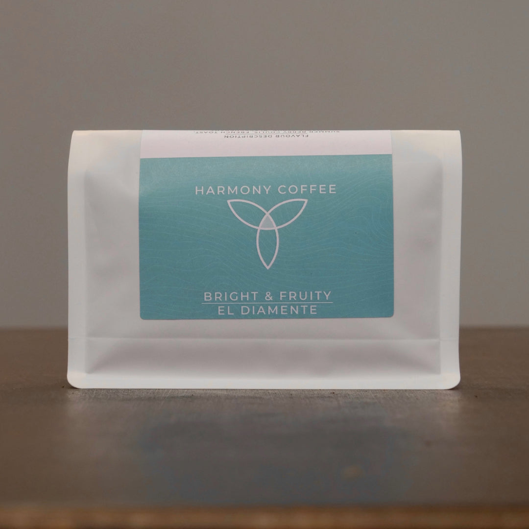 Harmony Coffee package on a wooden surface with a neutral background