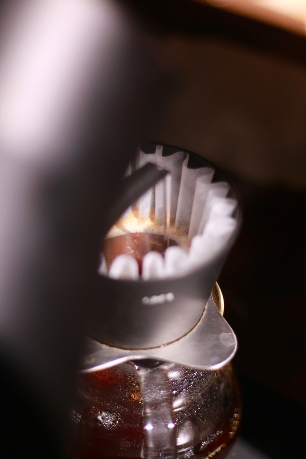 Close-up of a coffee filter with coffee grounds inside a coffee filter.