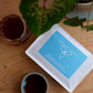 Harmony Coffee package with a cup of coffee on a wooden surface