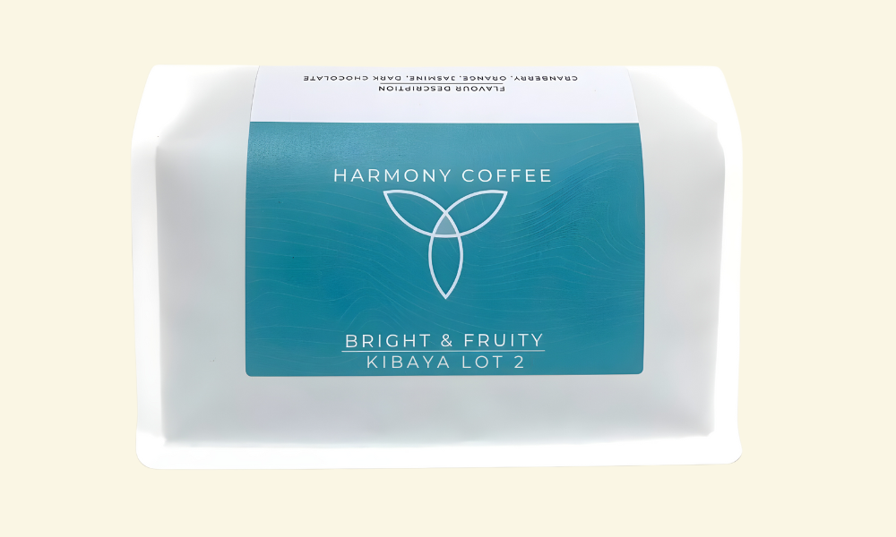 Harmony Coffee package with a blue label on a beige background. Kibaya Lot 2 from Rwamatamu, Rwanda.