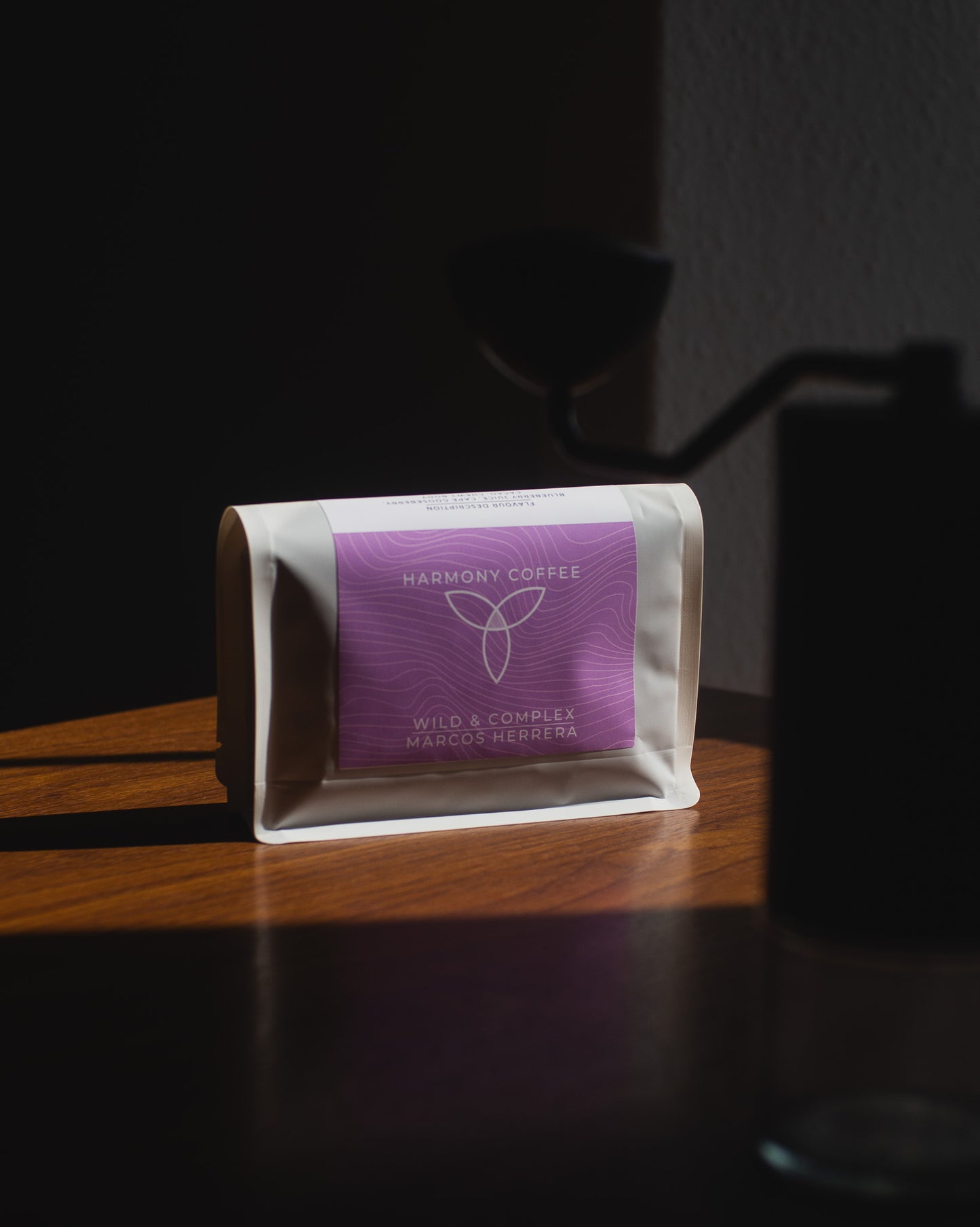 Harmony Coffee package with purple label on a wooden surface