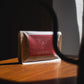 Harmony Coffee package on a wooden surface in direct sunlight.