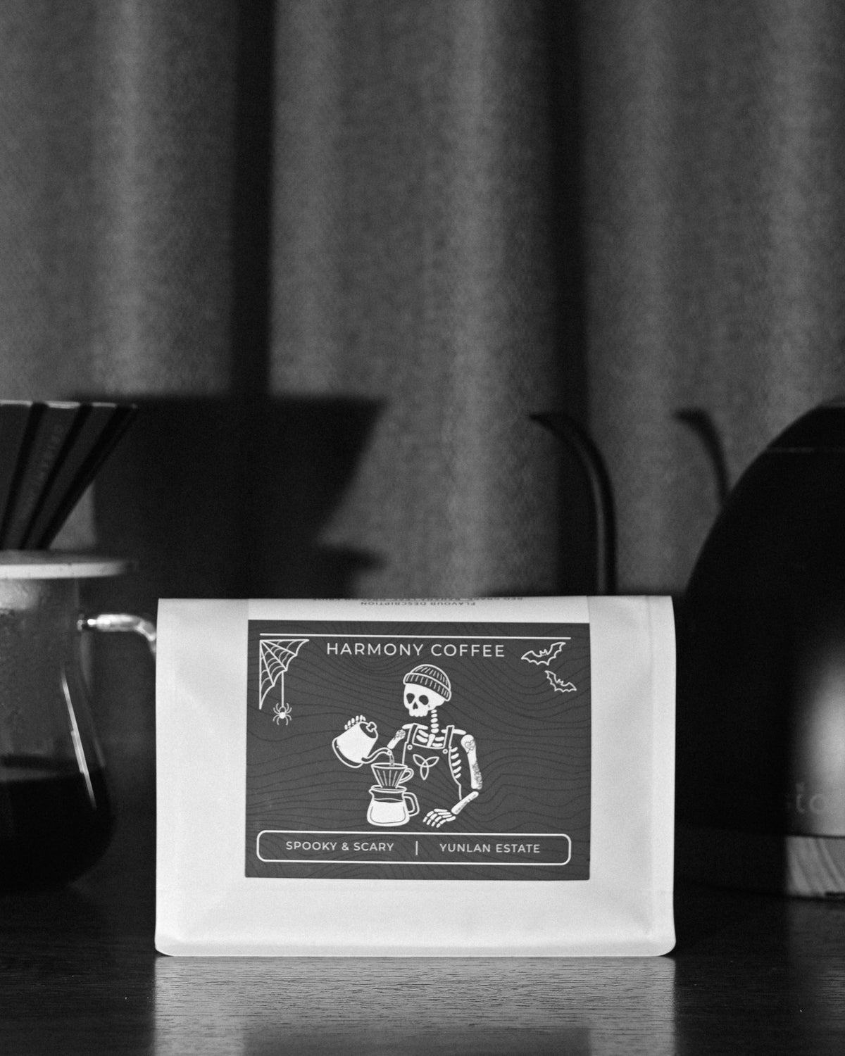 Spooky & Scary YunLan Estate coffee bag in front of a pour-over brewer and gooseneck kettle