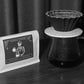 YunLan Estate natural Chinese coffee bag next to an origami dripper on a glass server of brewed coffee