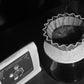 Pouring a filter coffee of YunLan Estate beside the Spooky & Scary bag, with red grape, banana leaf and dragonfruit flavour notes