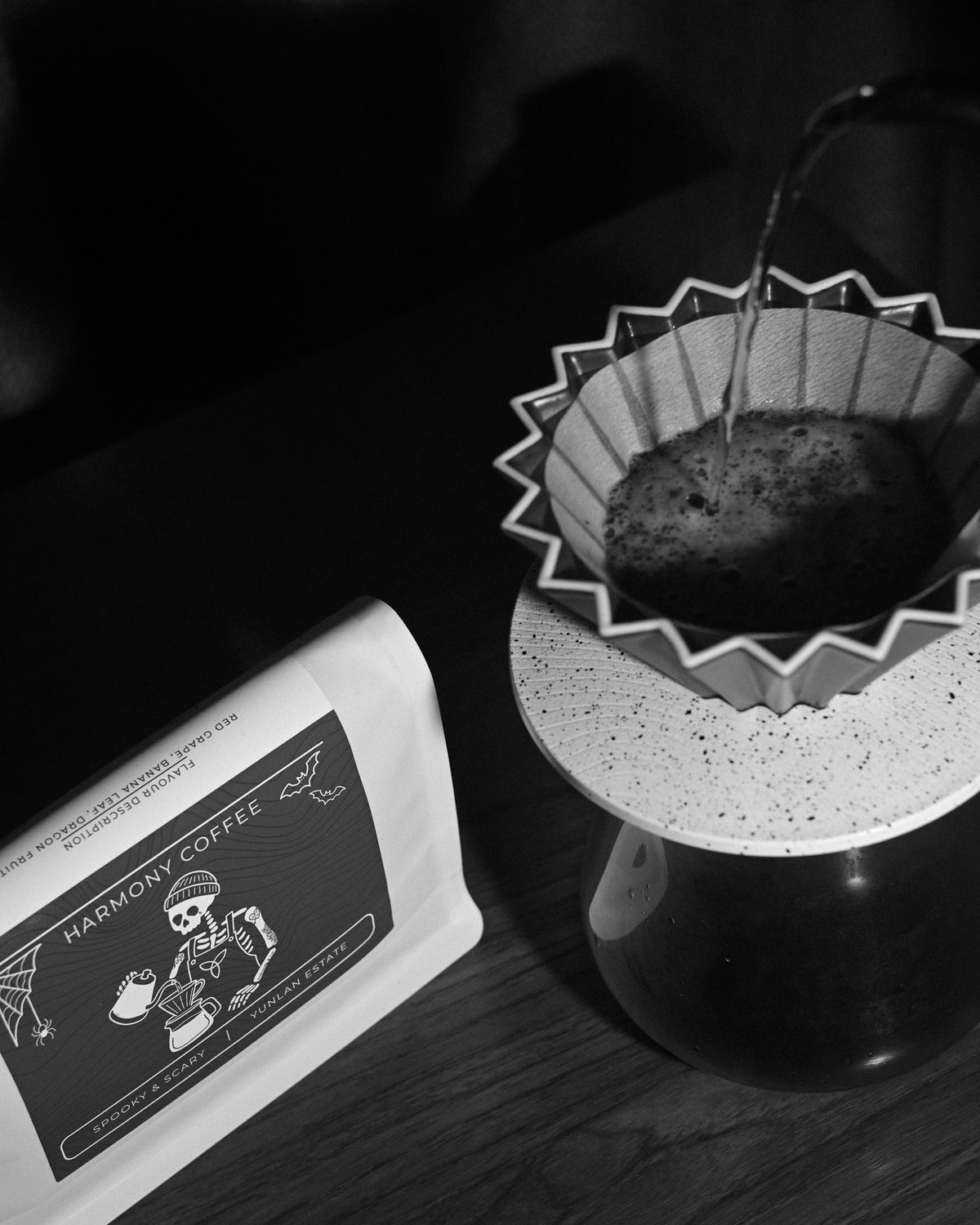Pouring a filter coffee of YunLan Estate beside the Spooky & Scary bag, with red grape, banana leaf and dragonfruit flavour notes