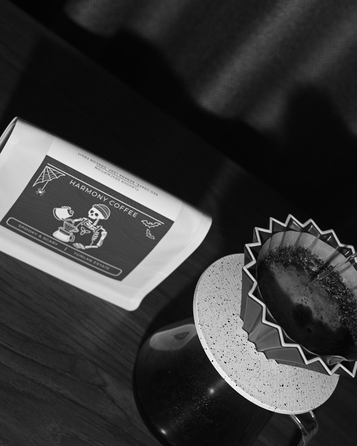 Overhead view of the Spooky & Scary YunLan Estate bag and an origami dripper mid-brew